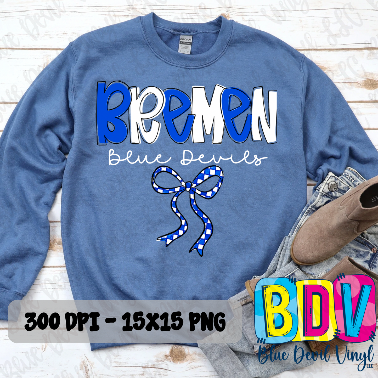 Blue long-sleeve shirt with 'Beemen Blue Devils' text and a bow graphic on a wooden surface.