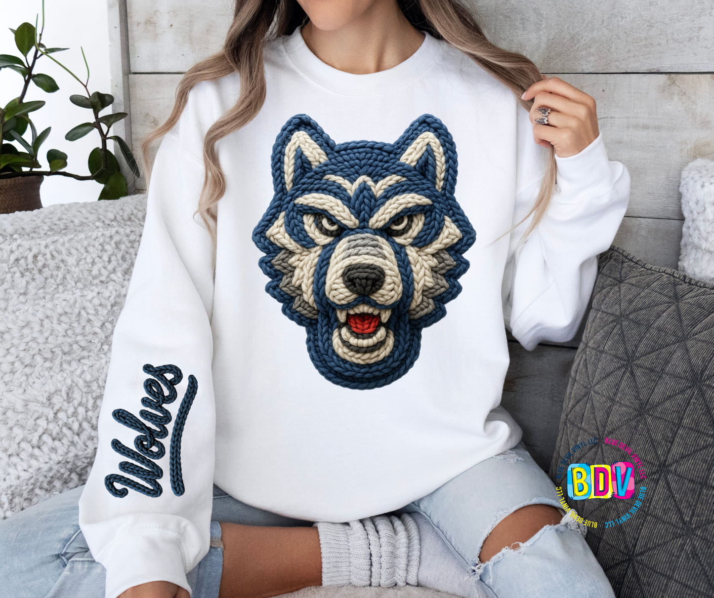White sweatshirt with a wolf design and 'Wolves' text on sleeve.